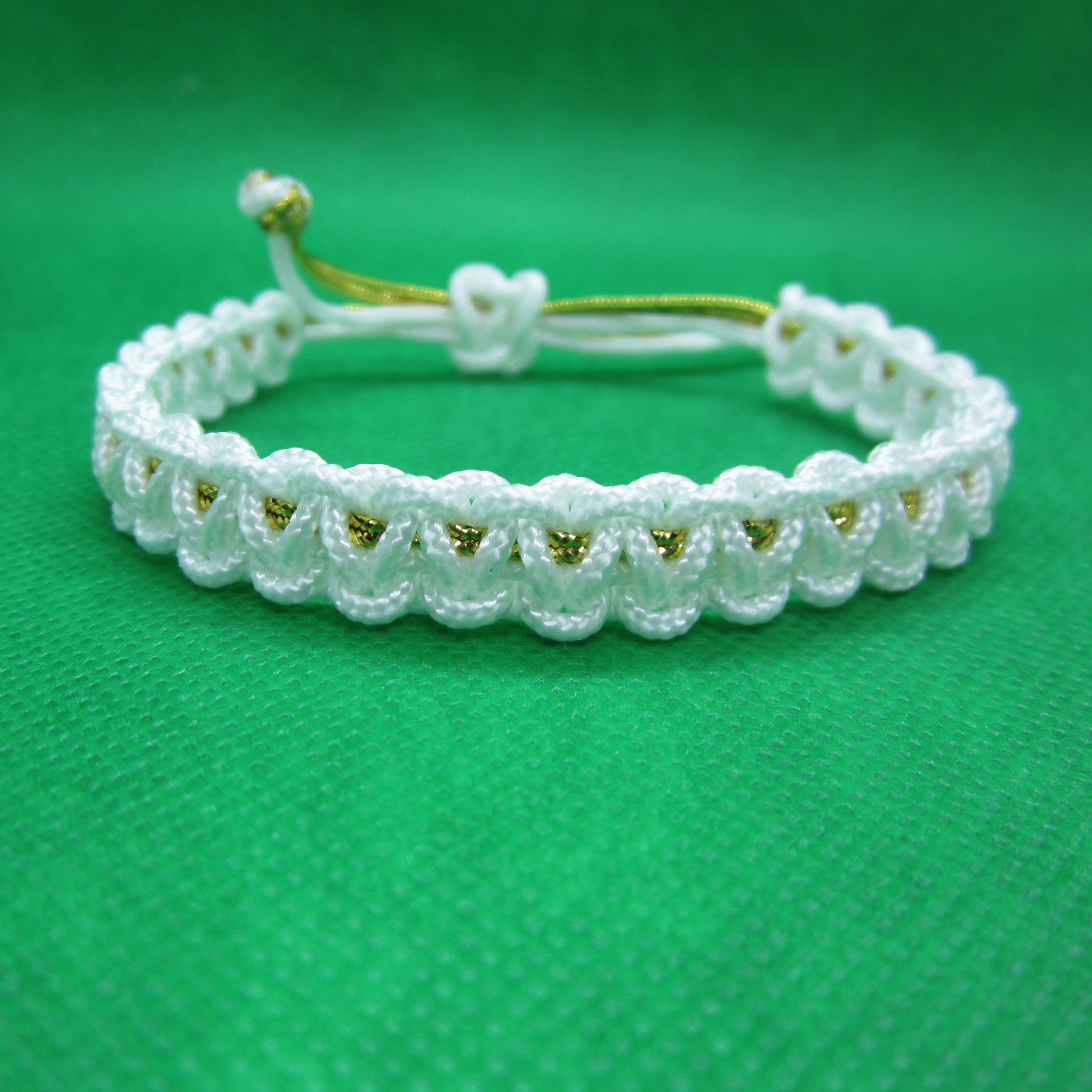 Bracelet white with golden cord